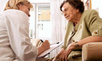 doctor having an appointment to an old woman