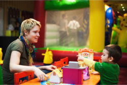 boy playing with his mom watching