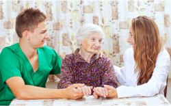 elderly woman with caregivers