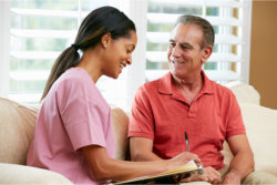 man talking to young caregiver